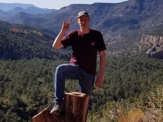 Michael Christoffersen displaying the "Hook-Em" hand sign
