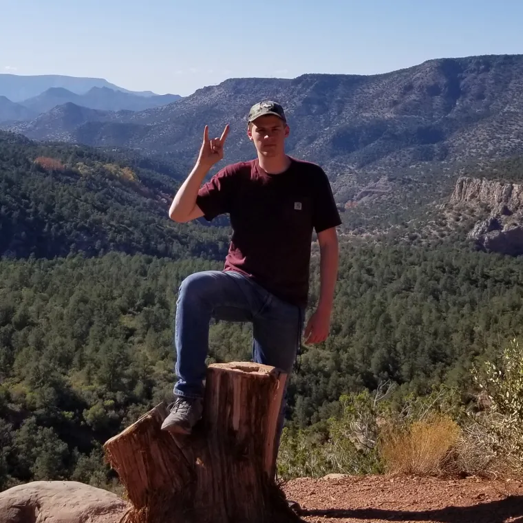 Michael Christoffersen displaying the "Hook-Em" hand sign